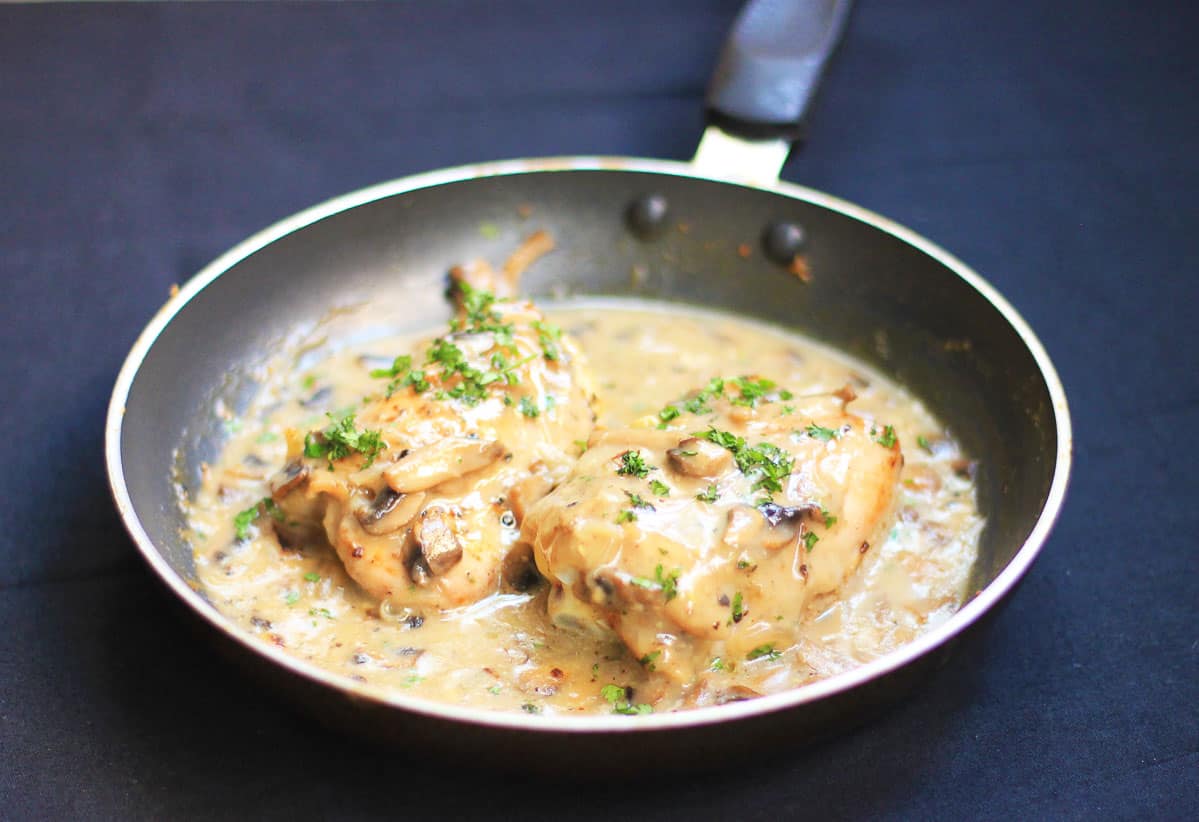 Chicken in Mushroom Sauce served in a black pan