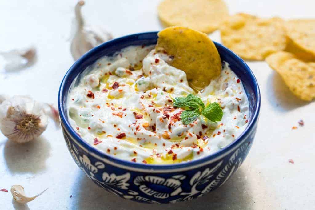 garlicky yogurt party dip served in a blue bowl