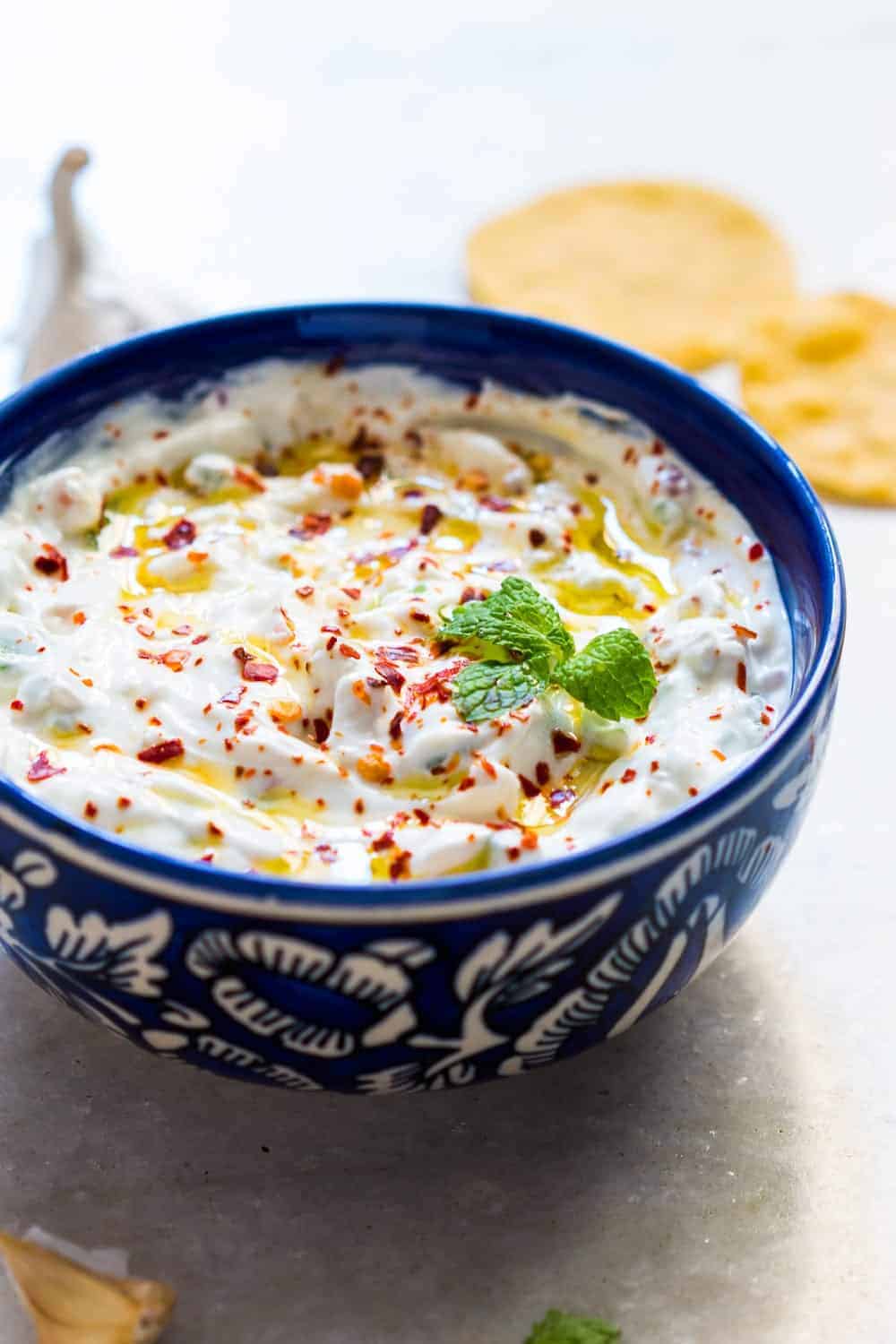 garlicky yogurt party dip served in a blue bowl