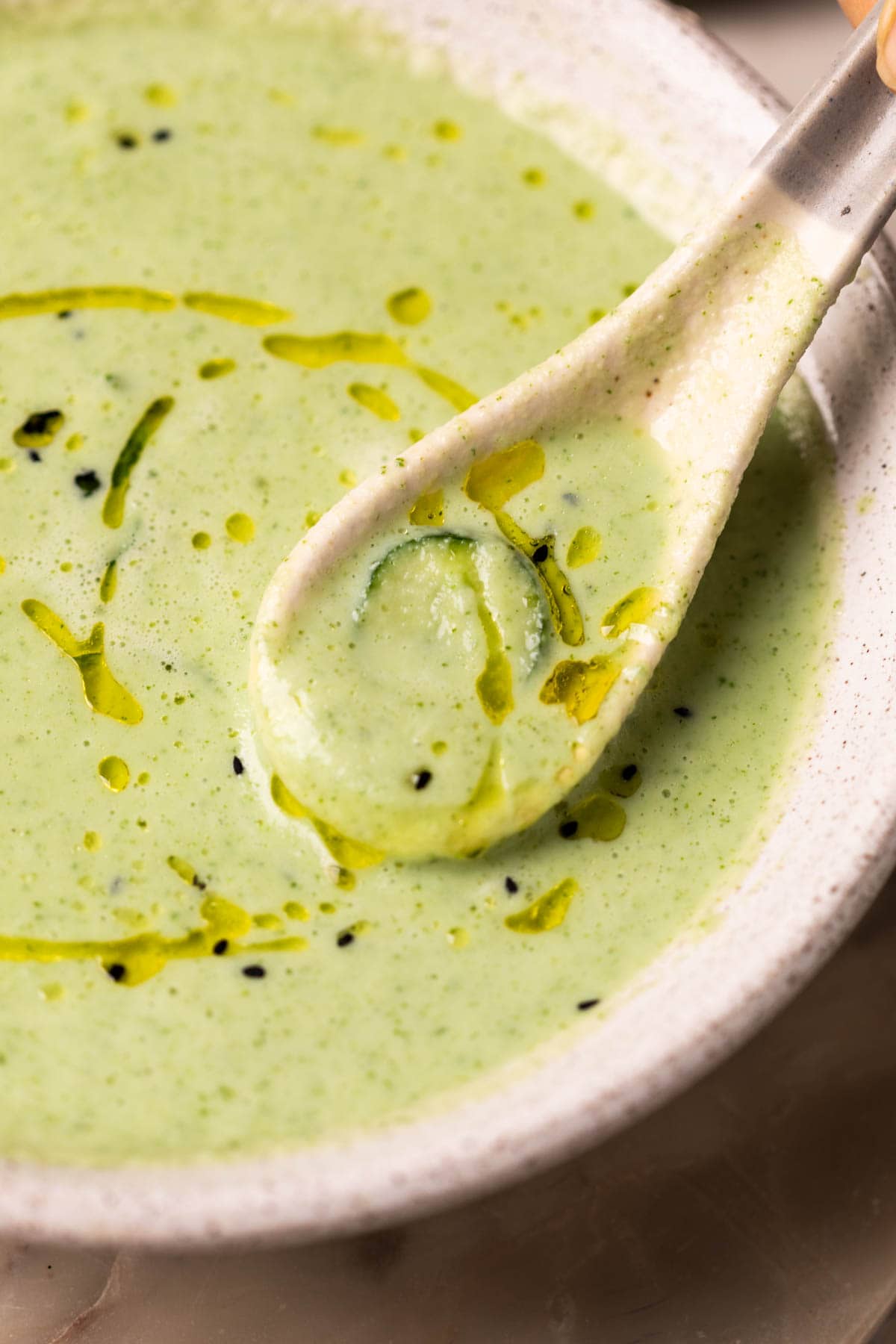 a close up image of cold cucumber soup to show it's creamy texture