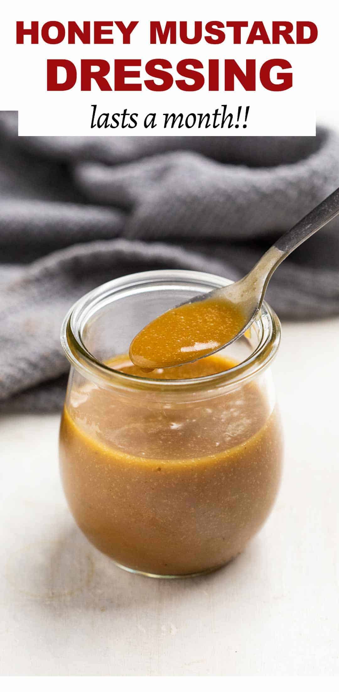 Honey mustard in a jar with a spoon being taken out