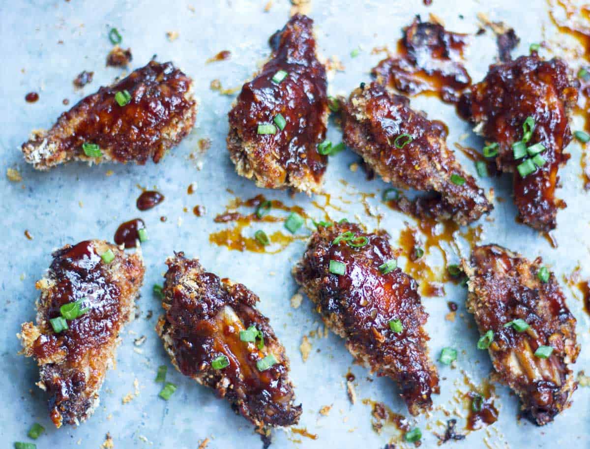 Baked Sticky Chicken Wings lined up on a tray.