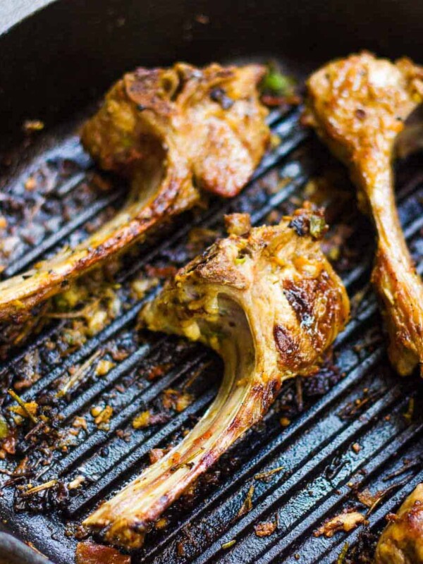 Spiced lamb chops in a pan.