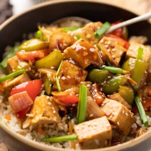 Sweet Chili Tofu Stir Fry served over rice in a bowl.