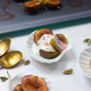 Roasted figs with cardamom yogurt served in tiny white bowls.