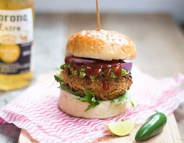 The Fully Loaded Veggie Burger with Avocado Mint Chutney served on a wooden board.