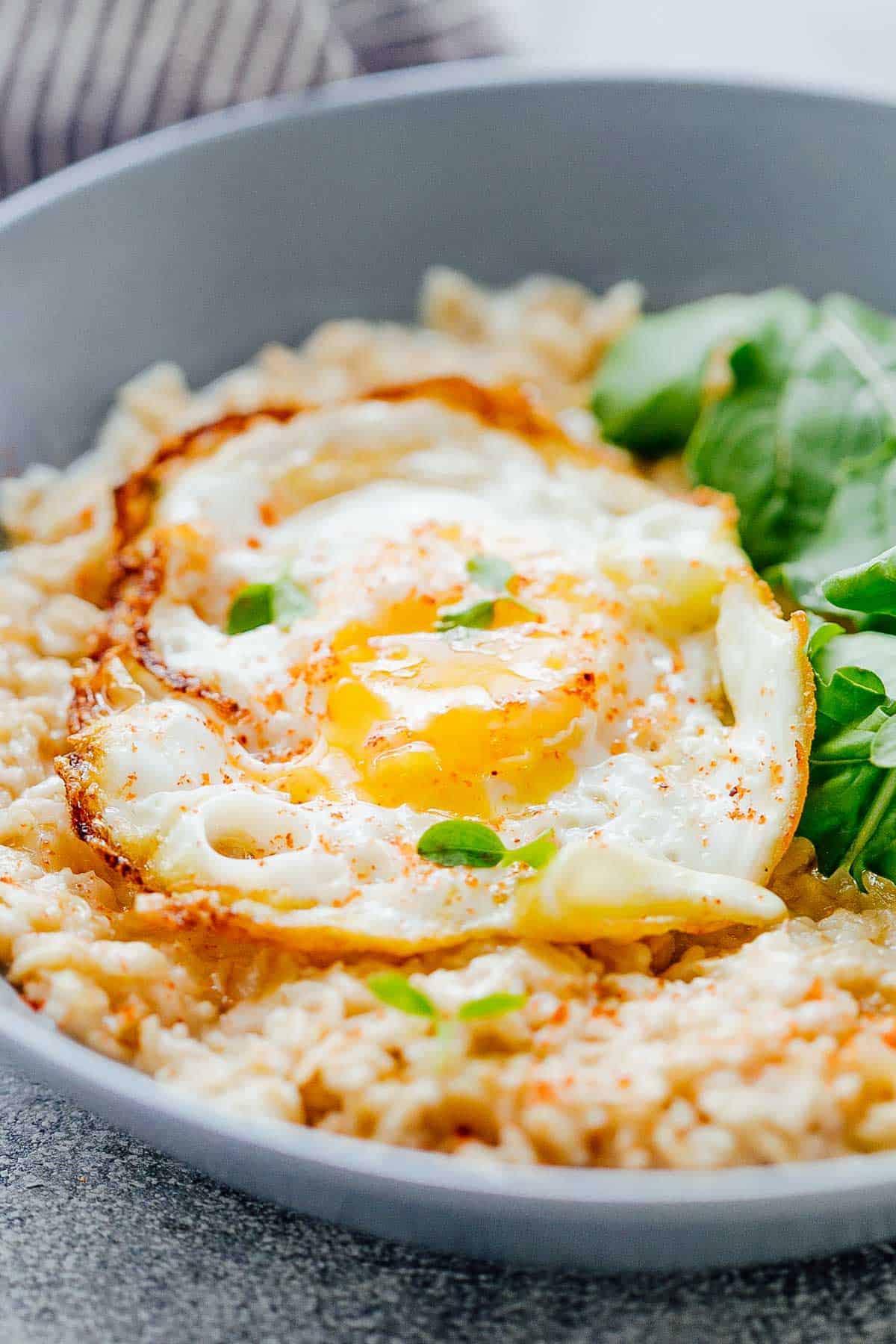 close up shot of the runny yolk in savory garlic oats with masala fried egg
