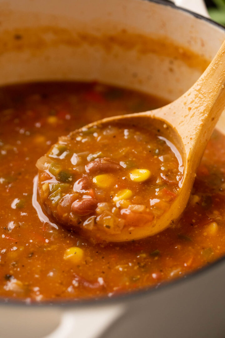 Picture of a ladle of a mexican soup being taken out of the soup pot