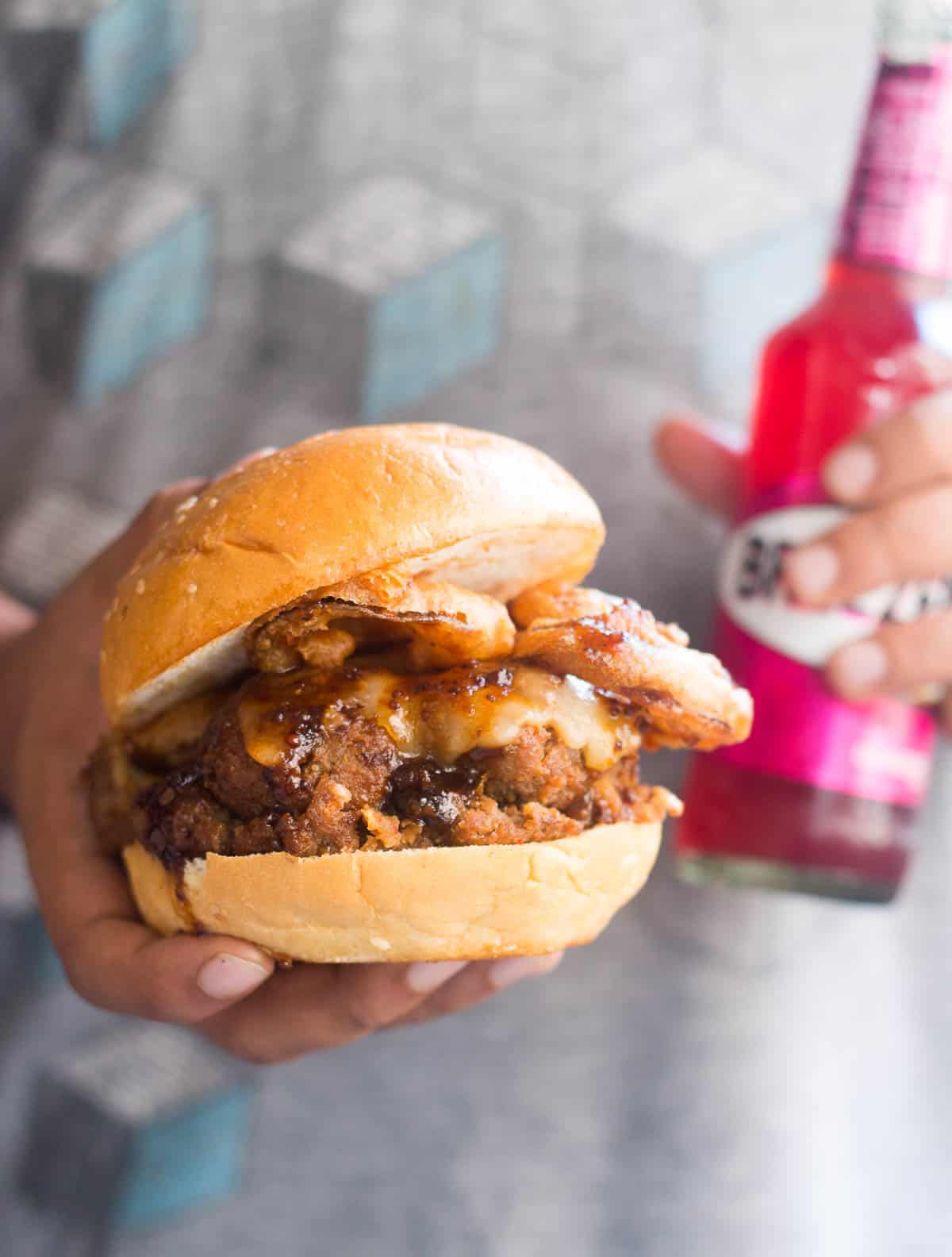 The badass burger being enjoyed with a Breezer!