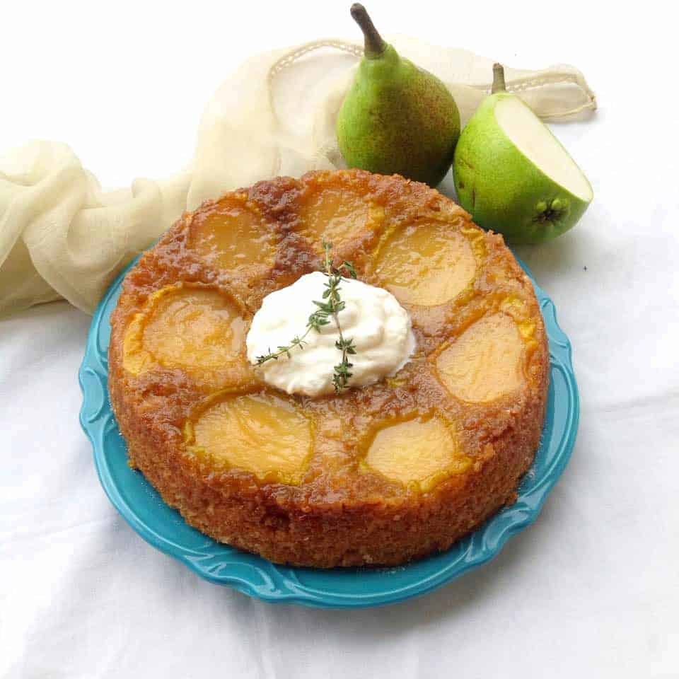 upside down pear cake served on a blue plate