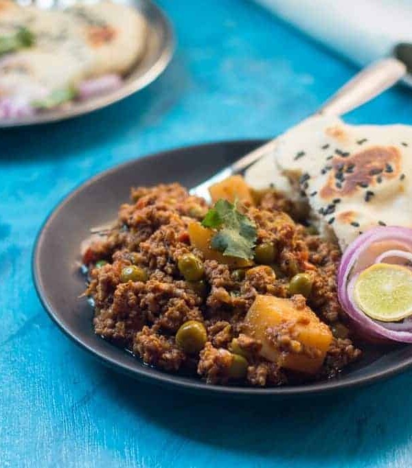 The mutton keema plated with naan, chopped onions and lime.