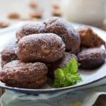 The fritters served in a white plate and garnished with mint leaves.