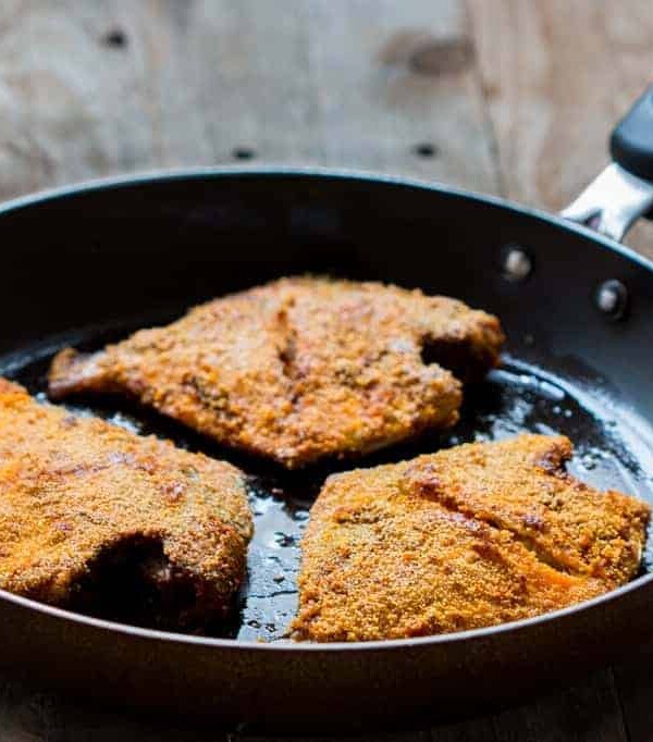 The fried fish coated with rava aka semolina in a pan.