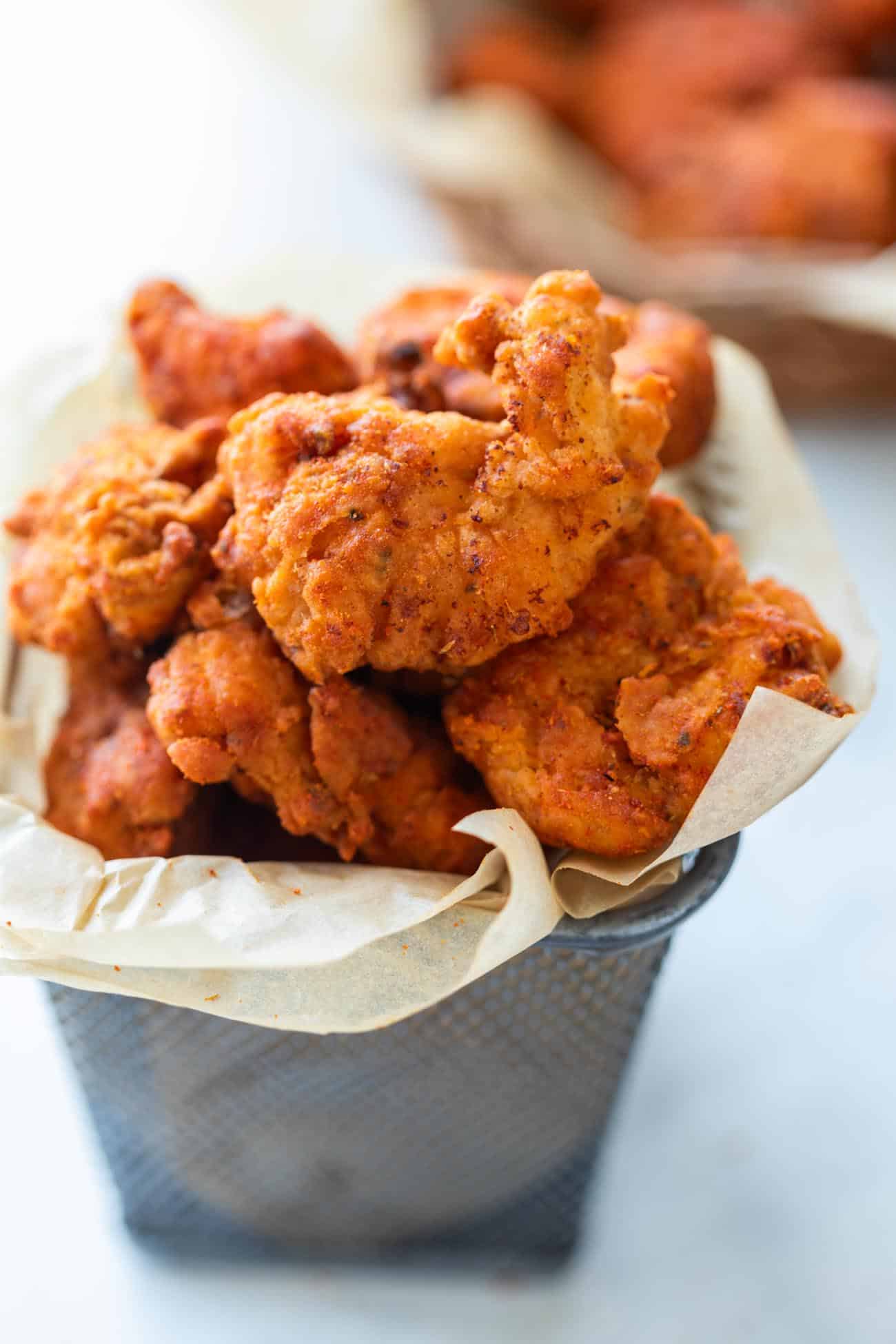 The popcorn chicken served in a mini bucket container.