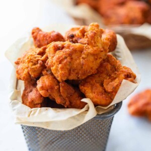 The popcorn chicken served in a mini bucket container.