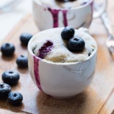 Blueberry oozing out from the Eggless Blueberry Microwave Mug Cake.