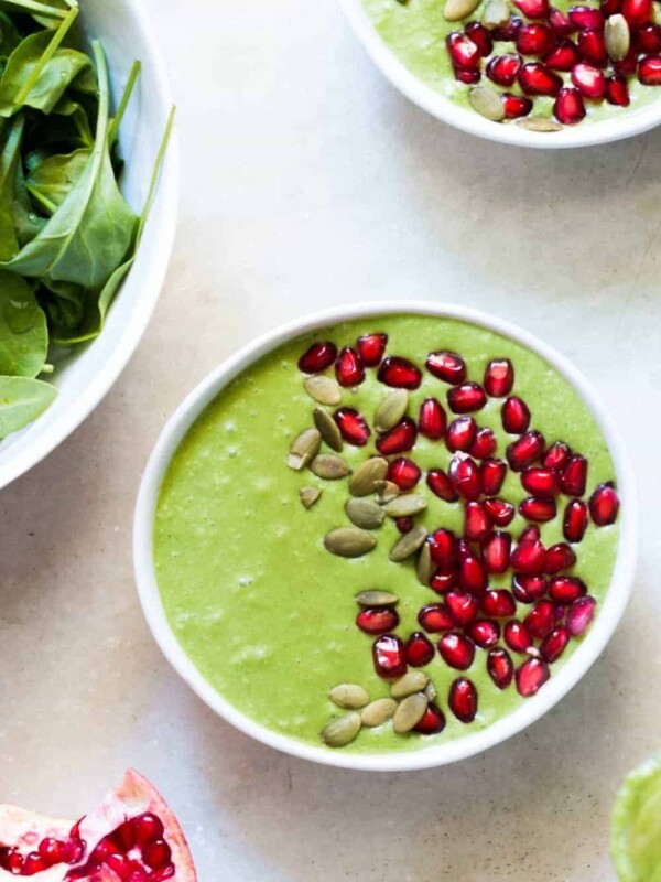 The smoothie bowl topped with pomegranate and pumpkin seeds.