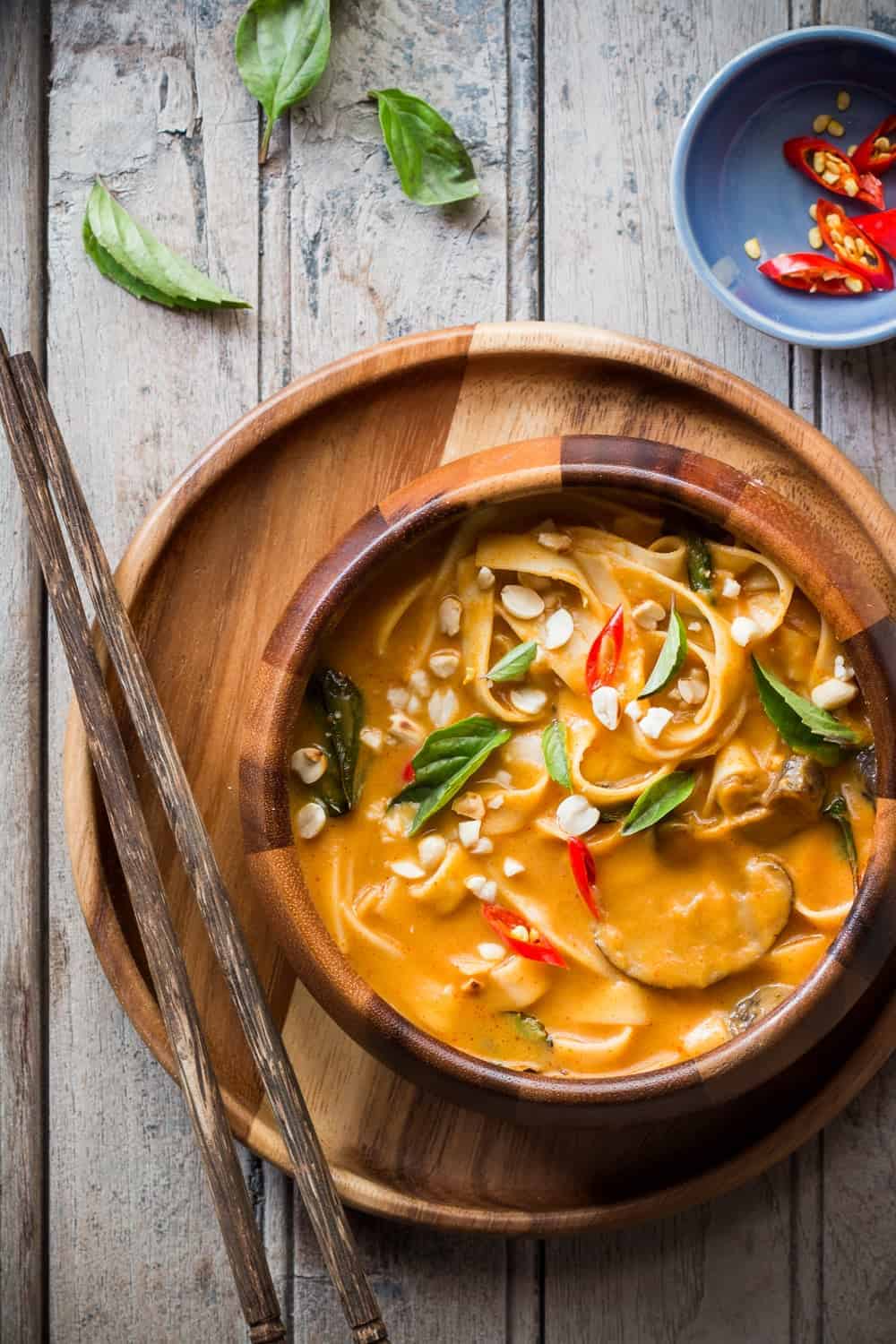 Creamy, comforting spicy thai curry pumpkin noodle soup gets ready in 20 minutes and the recipe takes you back to Thailand!