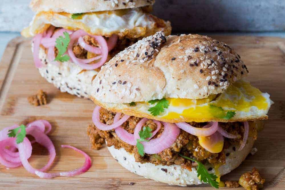 keema pav burger served on a brown board