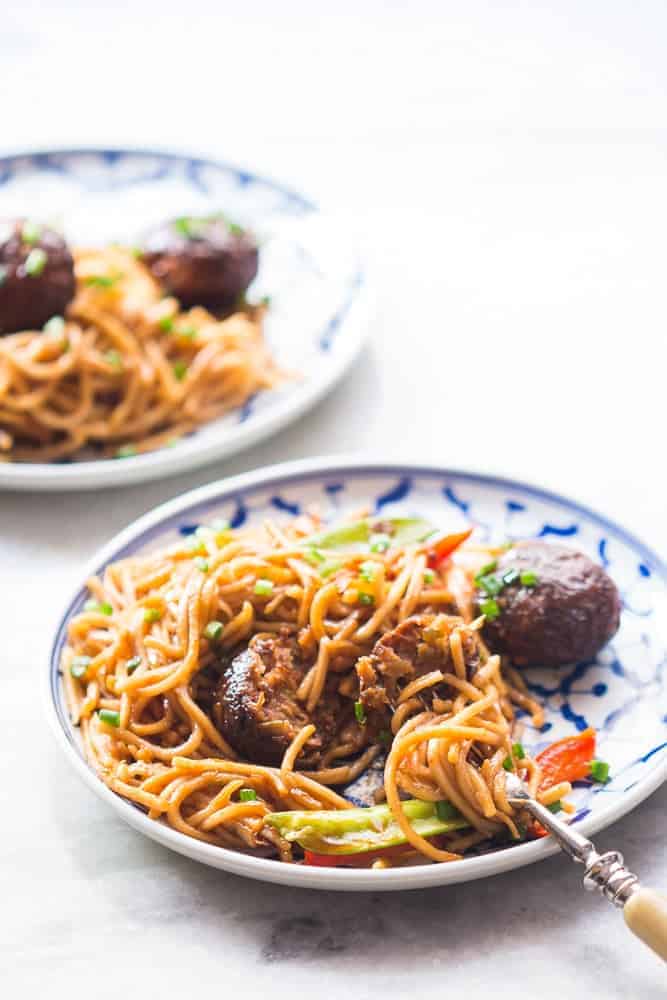 one pan veg noodle and manchurian stir fry served in a plate