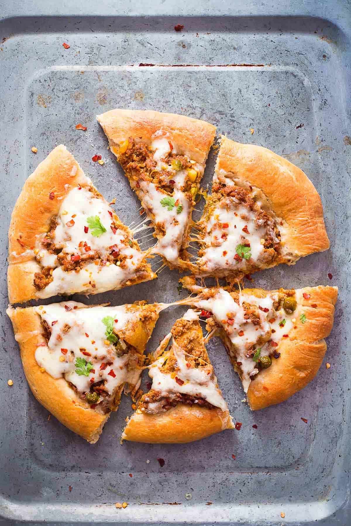 Wholewheat keema spice minced lamb pizza in a tray