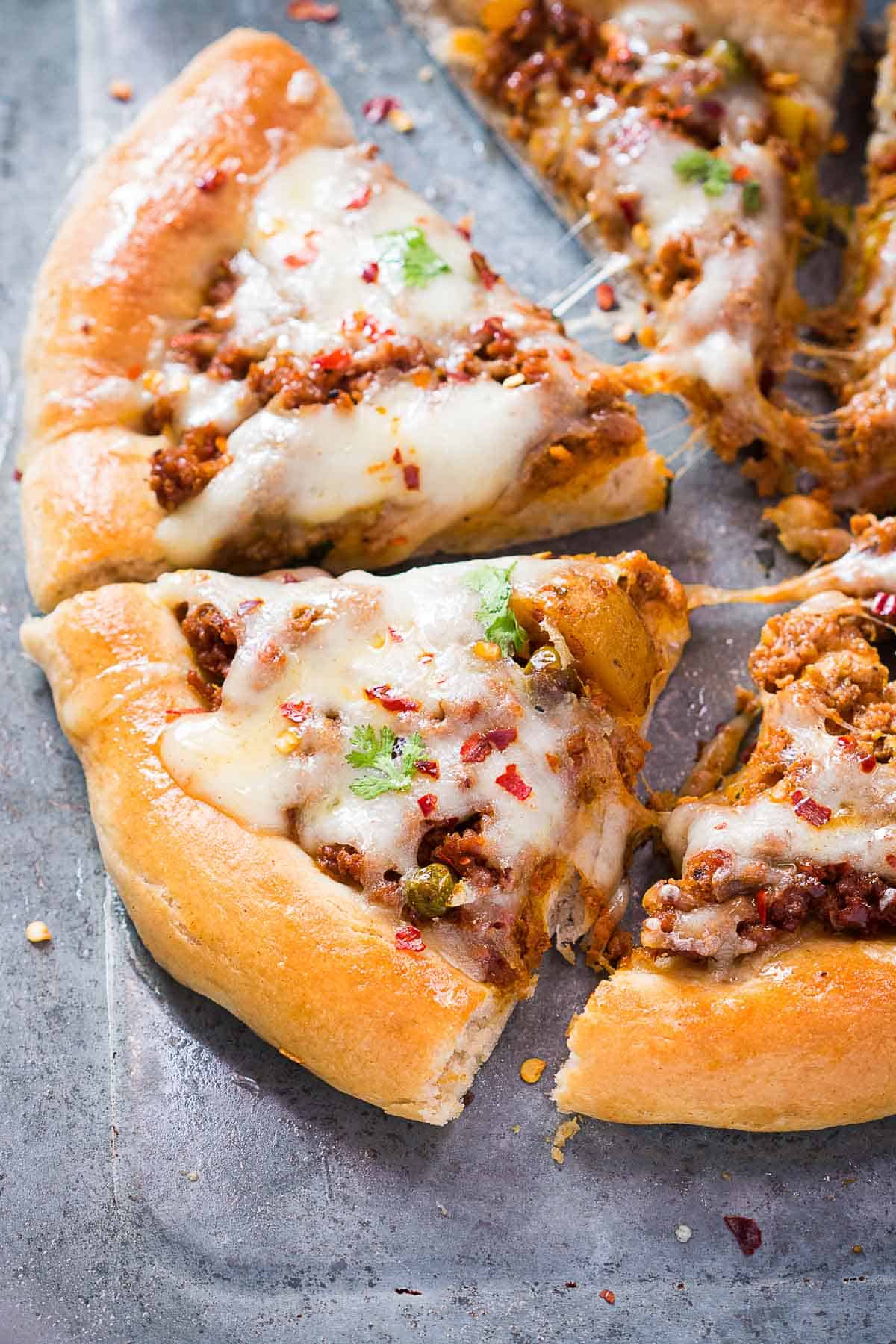 Close up shot of the sliced wholewheat kema spiced minced lamb pizza