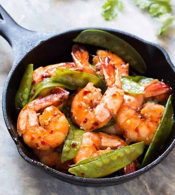 The chilli garlic prawns in a black pan.
