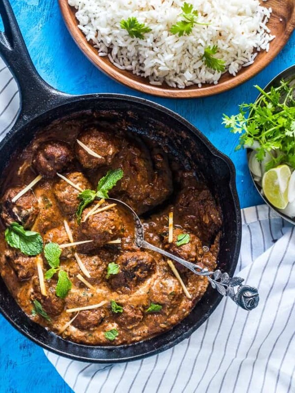 Easy One Pot Mutton (Lamb) Kofta Curry garnished with coriander and ginger and served alongside rice.