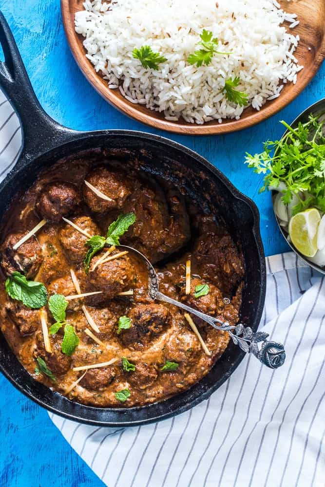 Easy One Pot Mutton (Lamb) Kofta Curry garnished with coriander and ginger and served alongside rice.