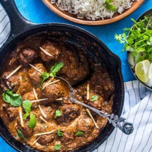 Easy One Pot Mutton (Lamb) Kofta Curry garnished with coriander and ginger and served alongside rice.