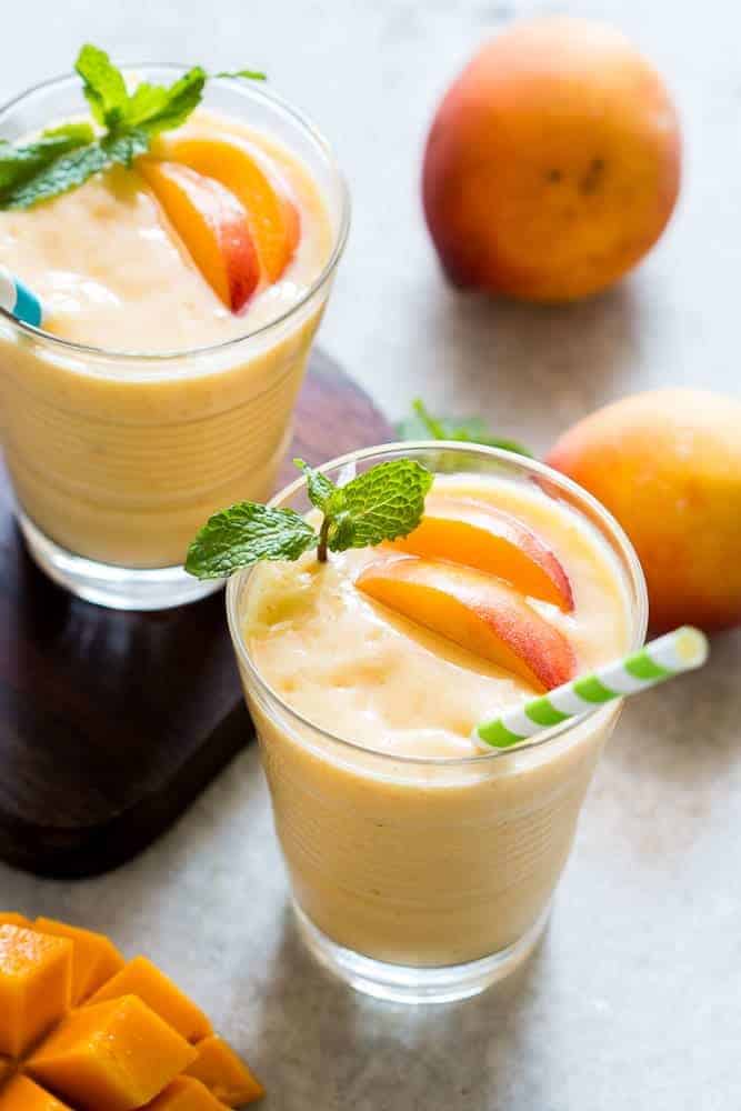 This healthy peach mango smoothie is vegan and the frozen fruit makes it thick and dessert like! Also get my top tips for making the best smoothies!