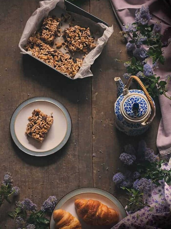 Raisin Chocolate and Puffed Rice Bar cut out and served on a white plate.