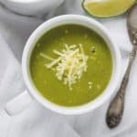Pressure Cooker Zucchini Basil Soup served in white cups with a side of bread.