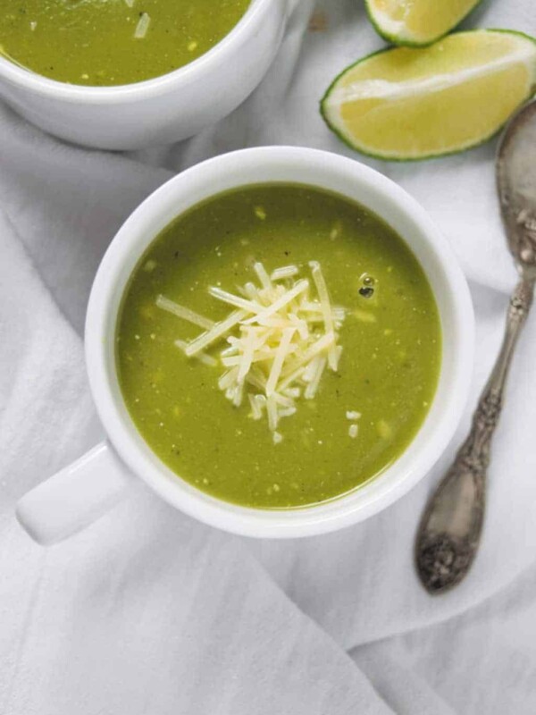Pressure Cooker Zucchini Basil Soup served in white cups with a side of bread.