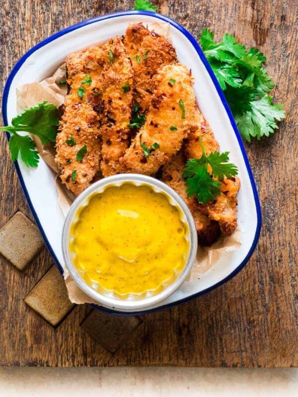Easy, healthy recipe for super crunchy GLUTEN FREE baked coconut crusted chicken tenders which are going to be a favourite with kids and adults alike! Move over greasy french fries, baked coconut chicken tenders are here to stay. Perfect for back to school kiddie lunches!