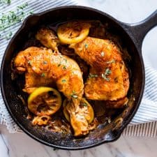 Caramelized Onion Thyme Lemon Chicken Legs in a black pan.
