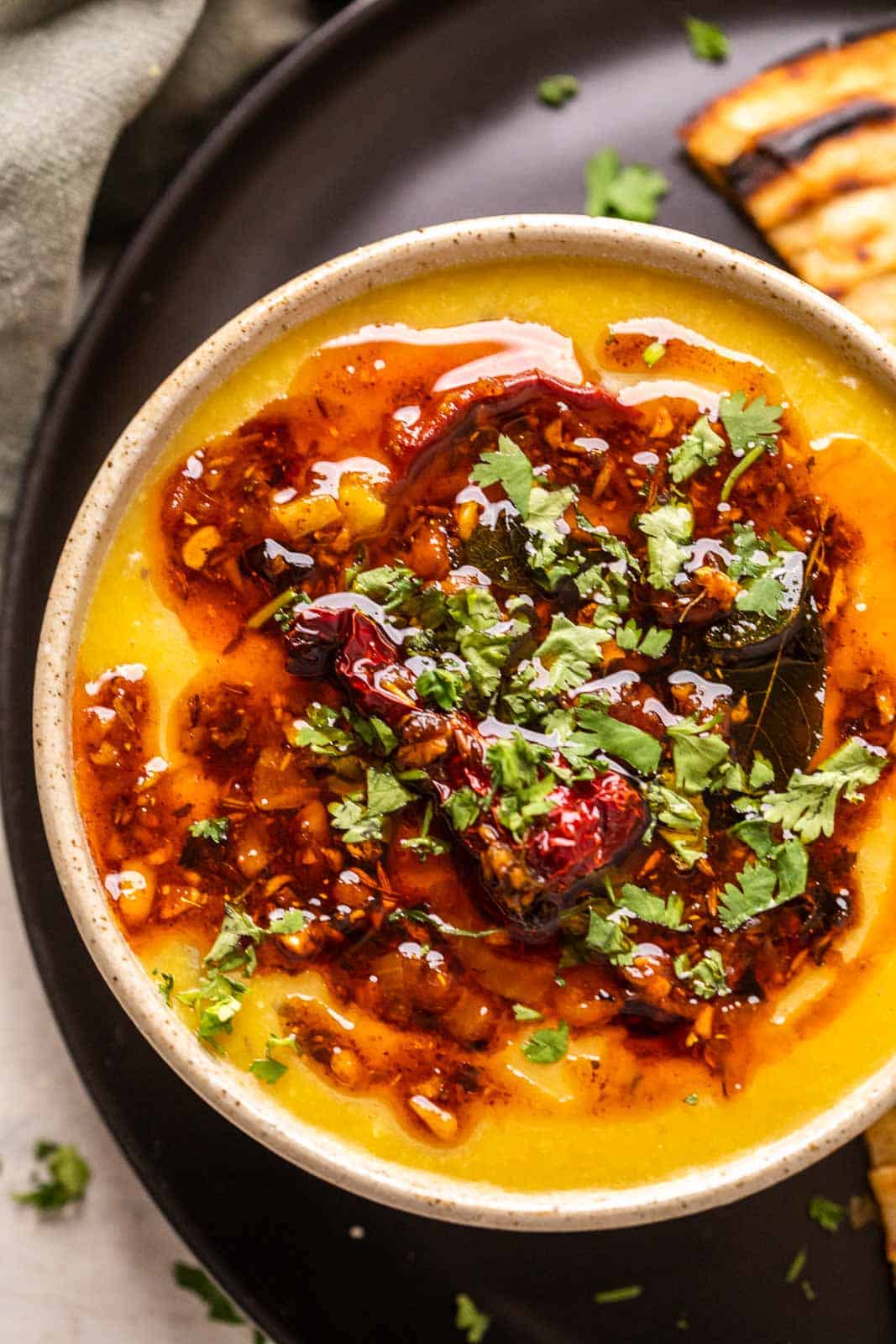 Closeup of dhaba dal tadka served in a ceramic bowl