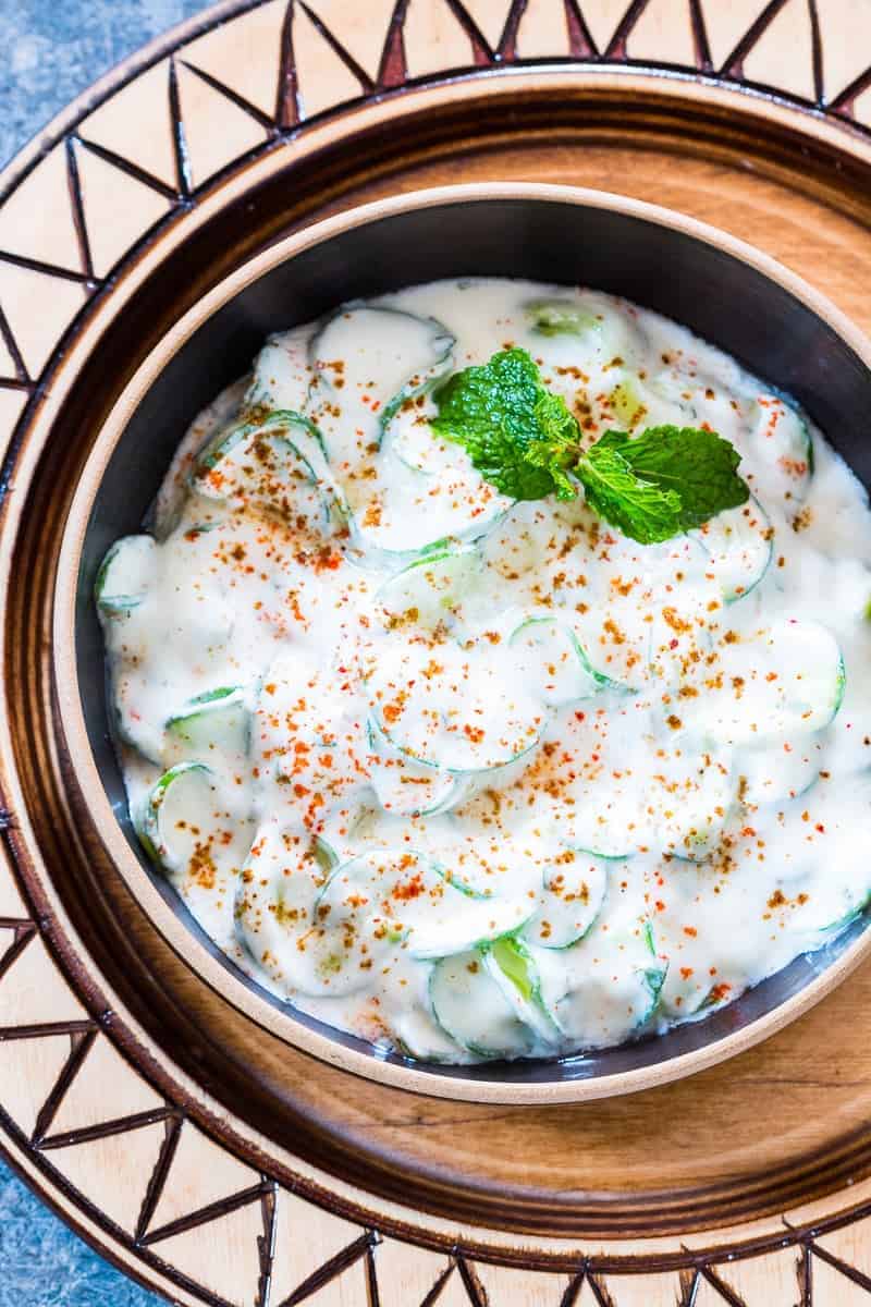 indian spiralized cucumber mint raita served in a black bowl