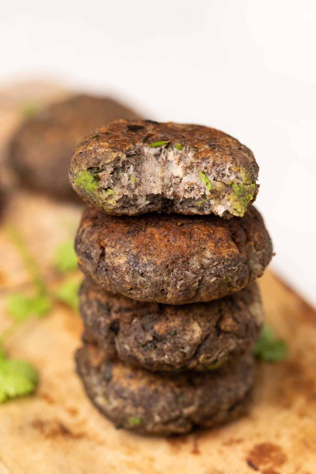 Kachhe kele ke kebab garnished and served on a brown board