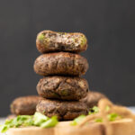 raw banana tikki or Kachhe kele ke kebab garnished and served on a brown board