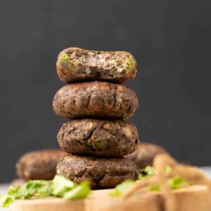 raw banana tikki or Kachhe kele ke kebab garnished and served on a brown board