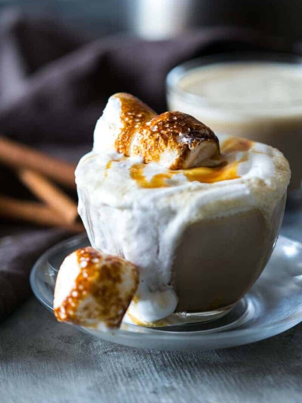 Homemade butterbeer latte topped with toasted marshmallows and served in a cup.