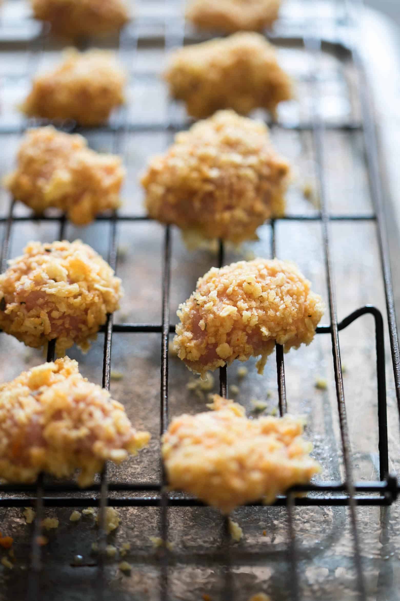 The easiest recipe for baked popcorn chicken that can be made two ways - spicy and non spicy! Tastes KFC style, but gluten free and guilt free for the perfect party appetizer.