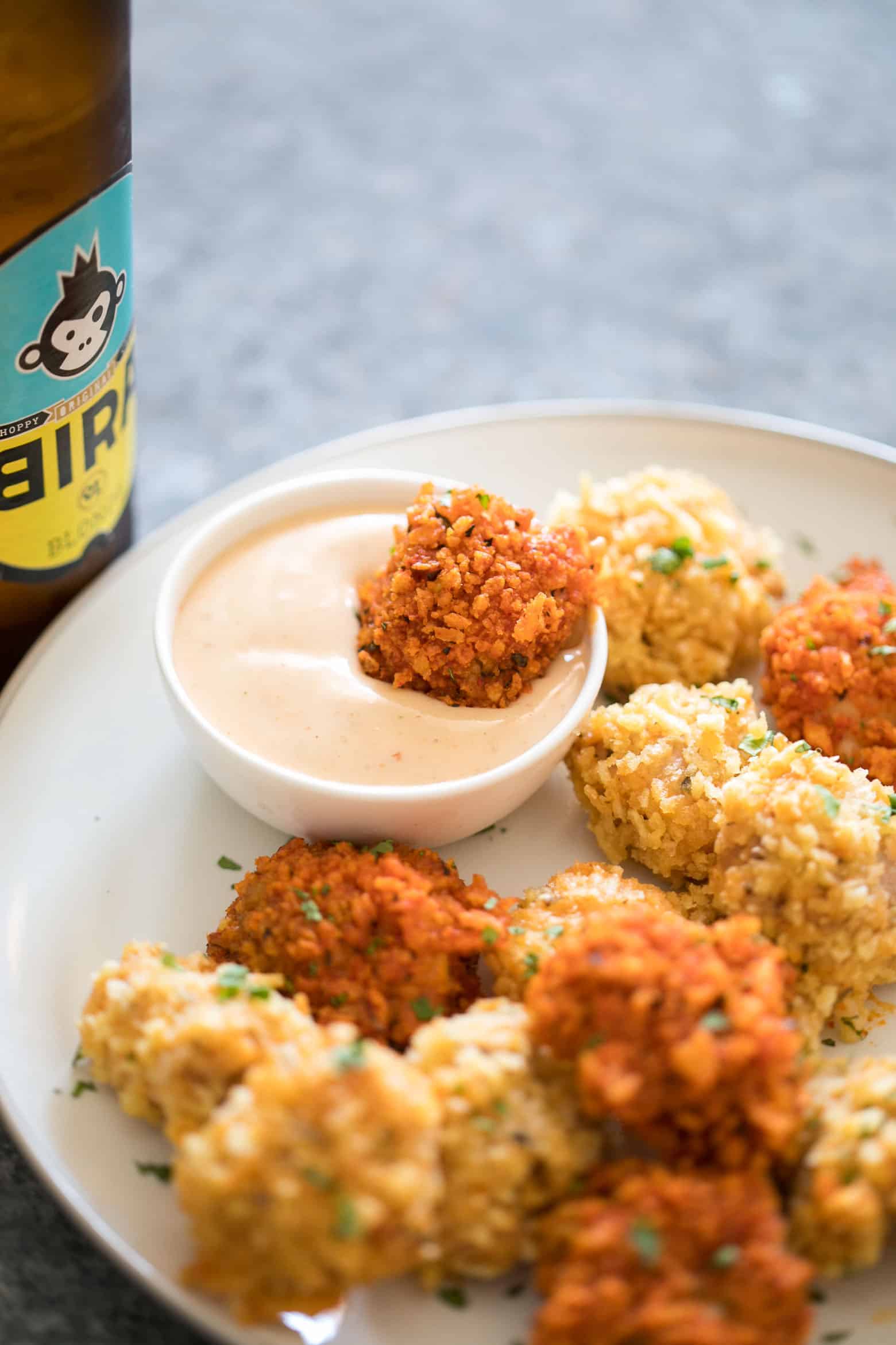 The easiest recipe for baked popcorn chicken that can be made two ways - spicy and non spicy! Tastes KFC style, but gluten free and guilt free for the perfect party appetizer.