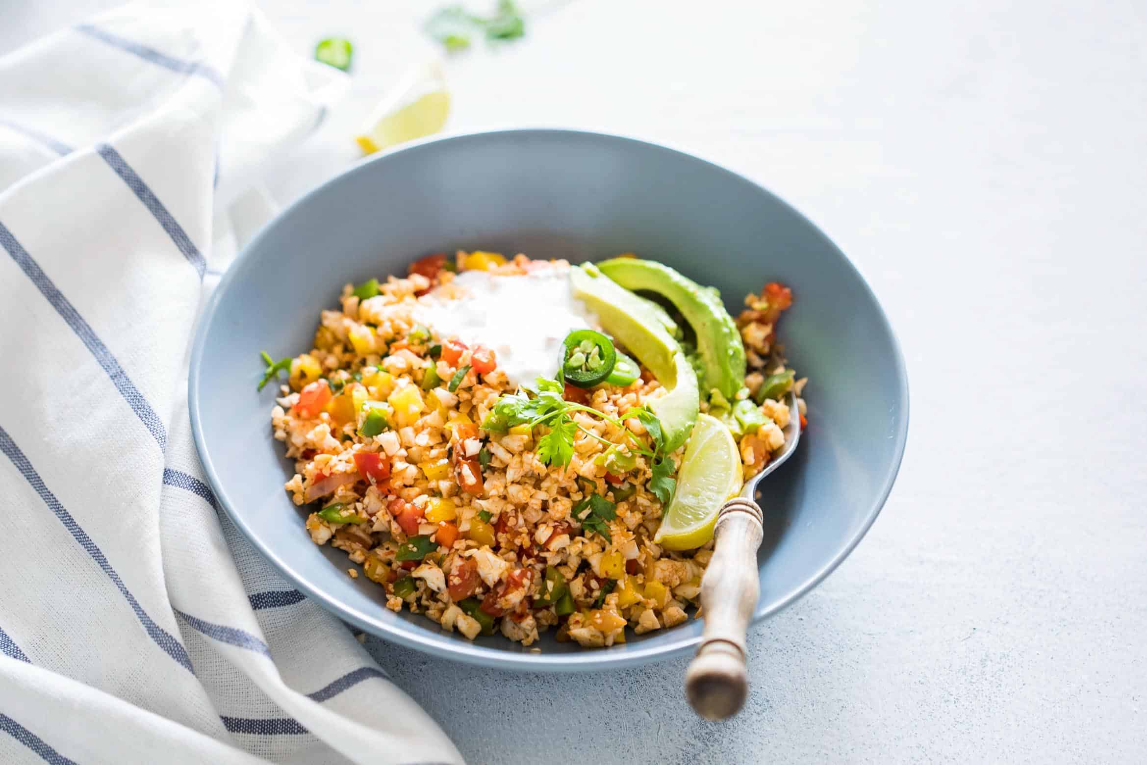 Low Carb Mexican Cauliflower Rice is a healthy, paleo friendly, keto friendly, vegan side dish recipe that is bursting with mexican flavours and ready in 30 minutes!