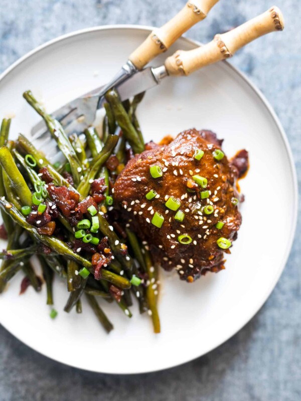 Spicy Korean Chicken Thighs in Gochujang Sauce served on a white plate.