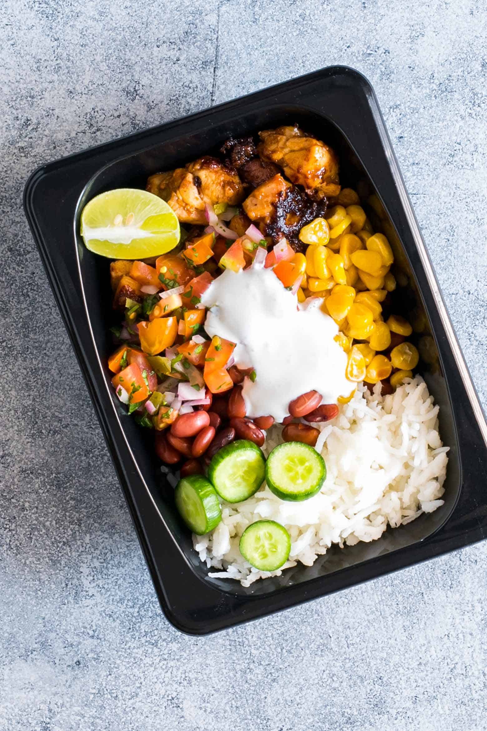 Easy chicken burrito meal prep bowls are perfect for planning weekday work lunches ahead! They are super tasty, gluten free and a healthy way to make sure you have home cooked lunch boxes ready to go.