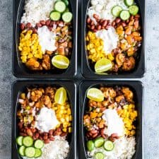 Chicken Burrito meal made ahead for the week and stored in a black refrigerator and microwave friendly box!