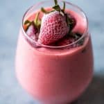 Strawberry Greek Yogurt smoothie blended till creamy and served in a glass.