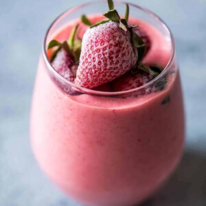 Strawberry Greek Yogurt smoothie blended till creamy and served in a glass.
